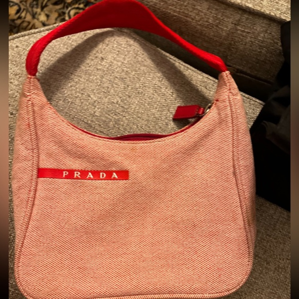 Prada bag
Several small stains on bag.